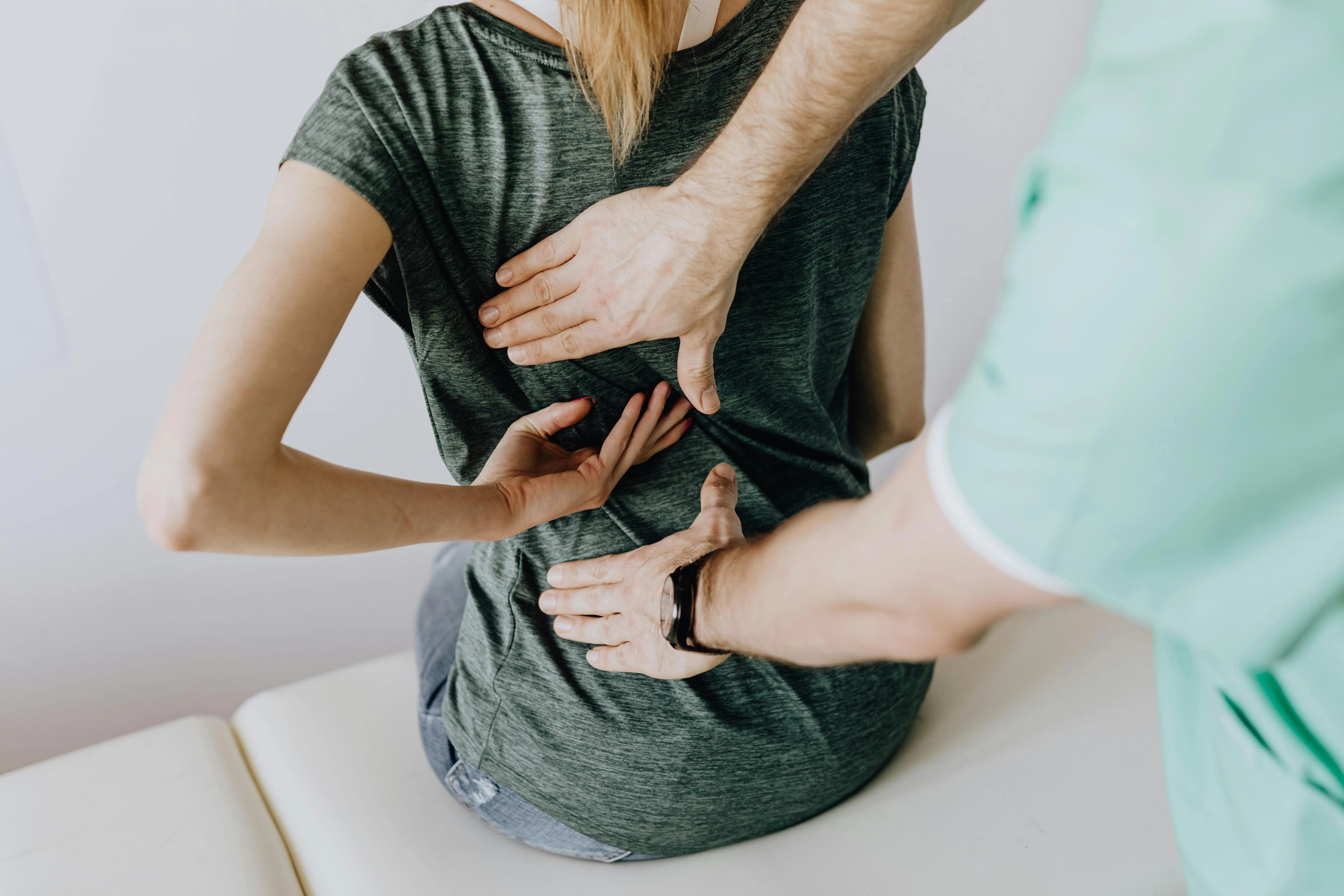 Doctor treating patient with back pain