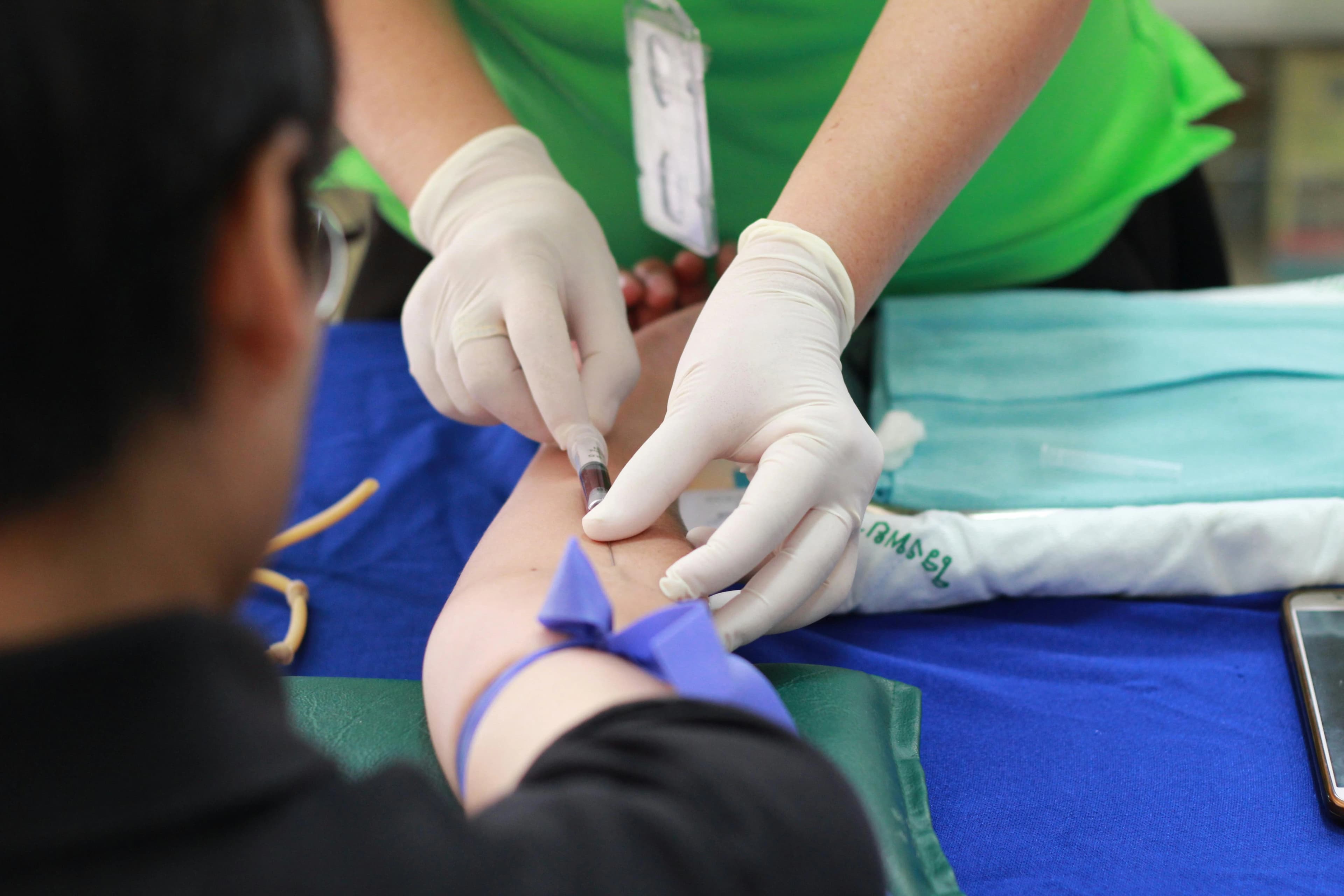 Doctor examining patient with stethoscope